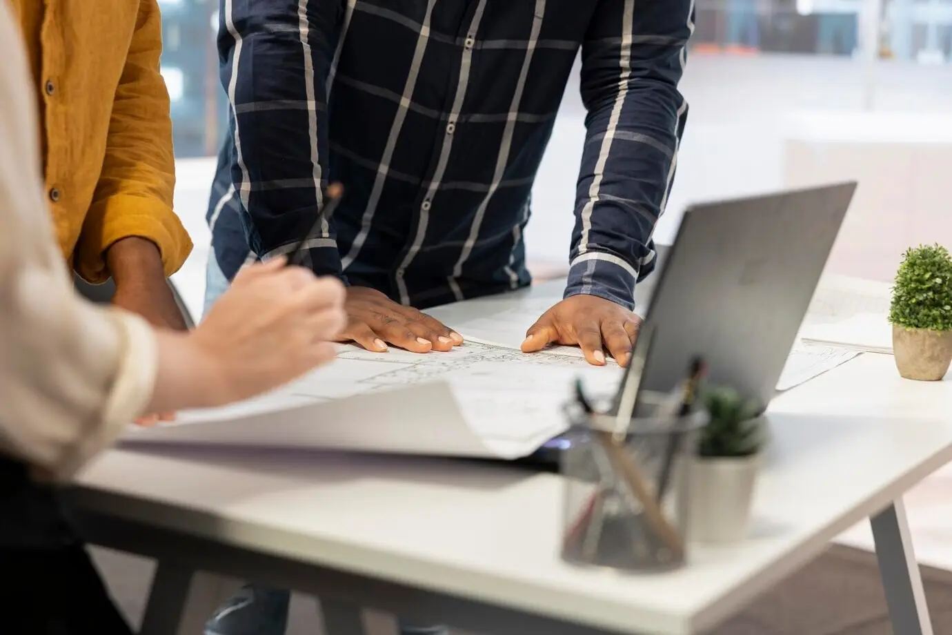 An entrepreneur and real estate agents collaborate on planning a corporate office.